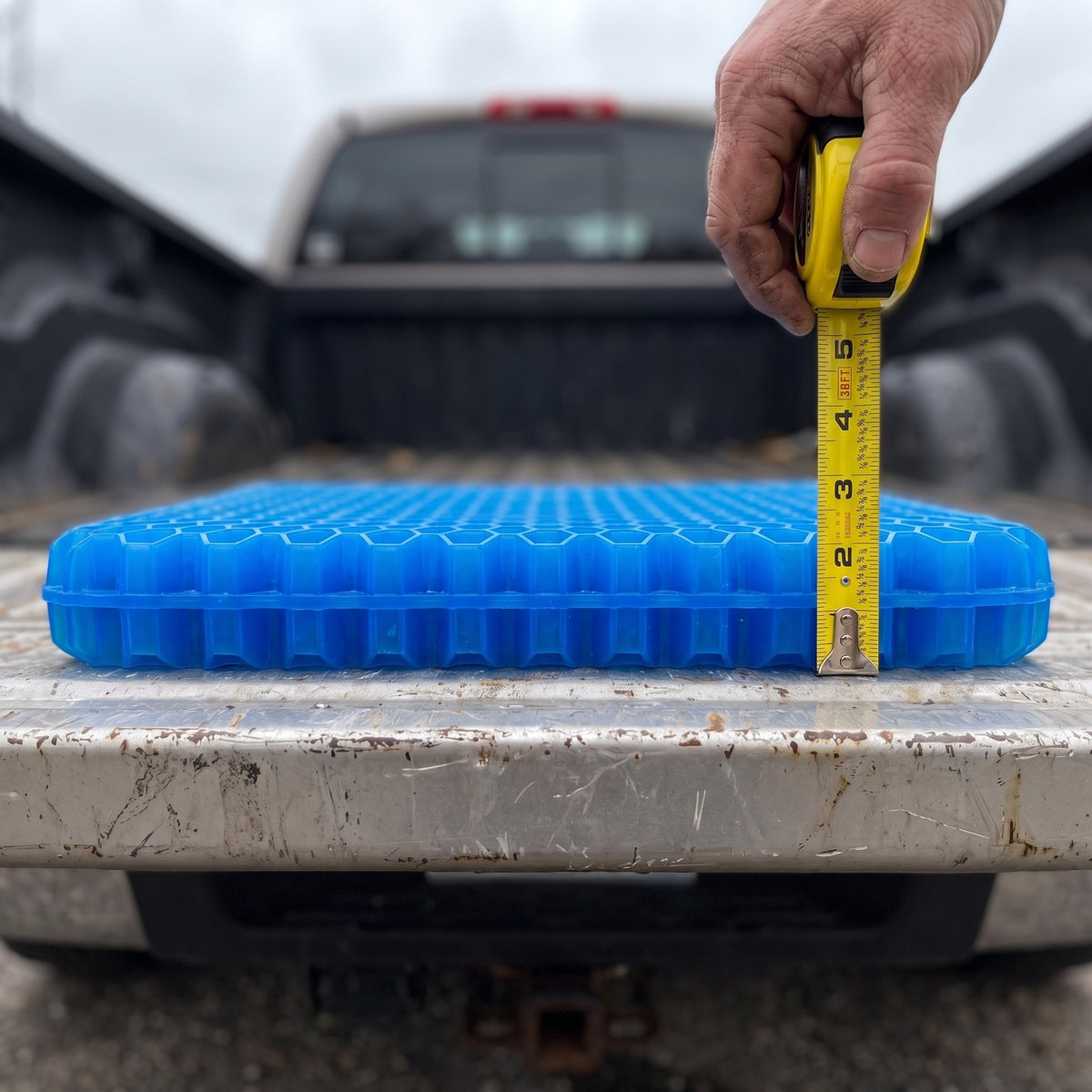 Hand holding a tape measure against the Wovaire Gel+ showing it is 2.4 inches thick